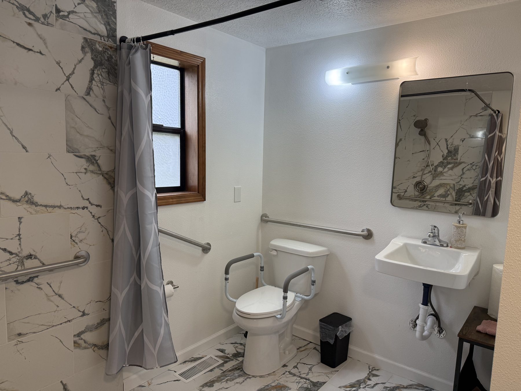 Toilet with support arms and grab bars