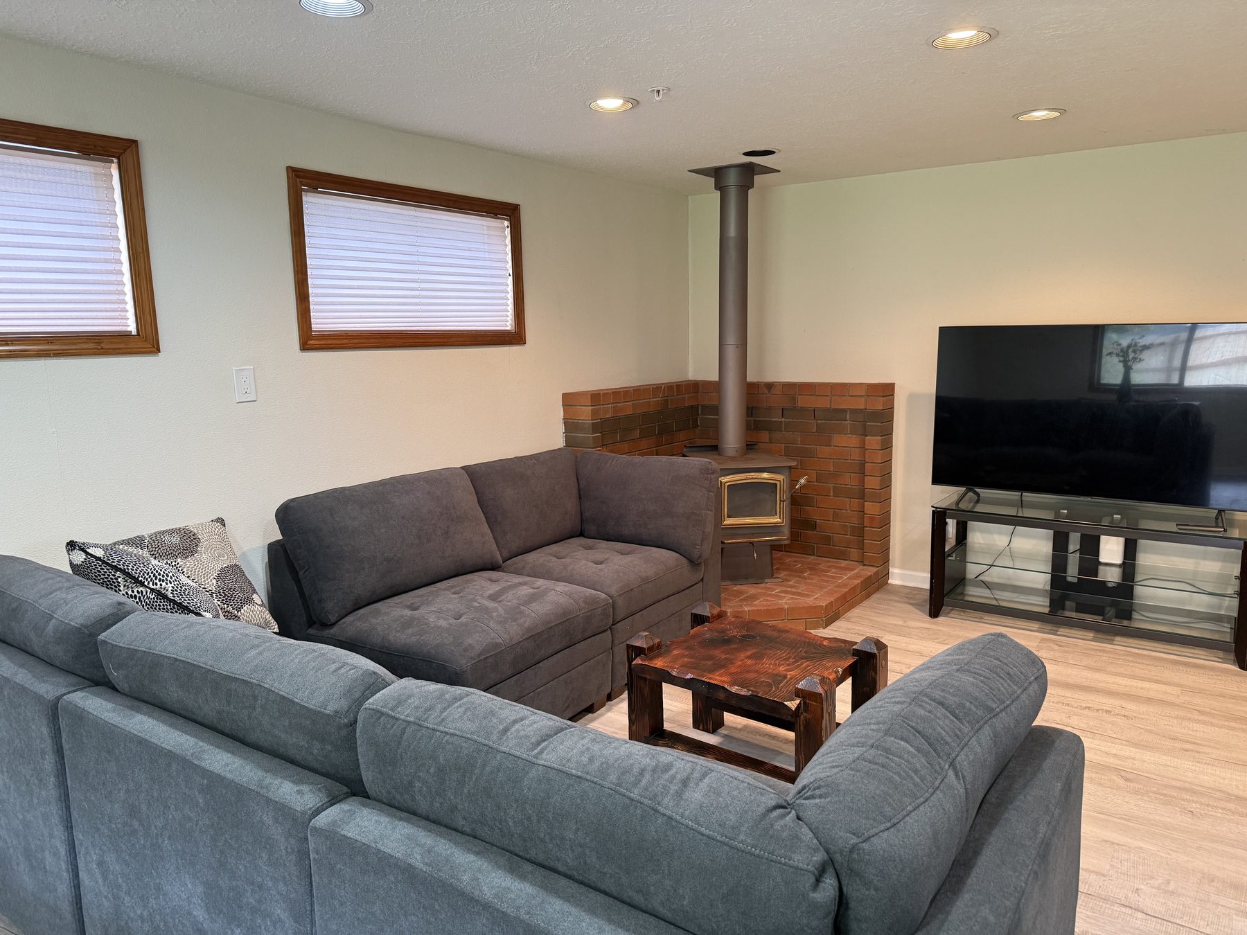Living room with seating, television, and wood stove